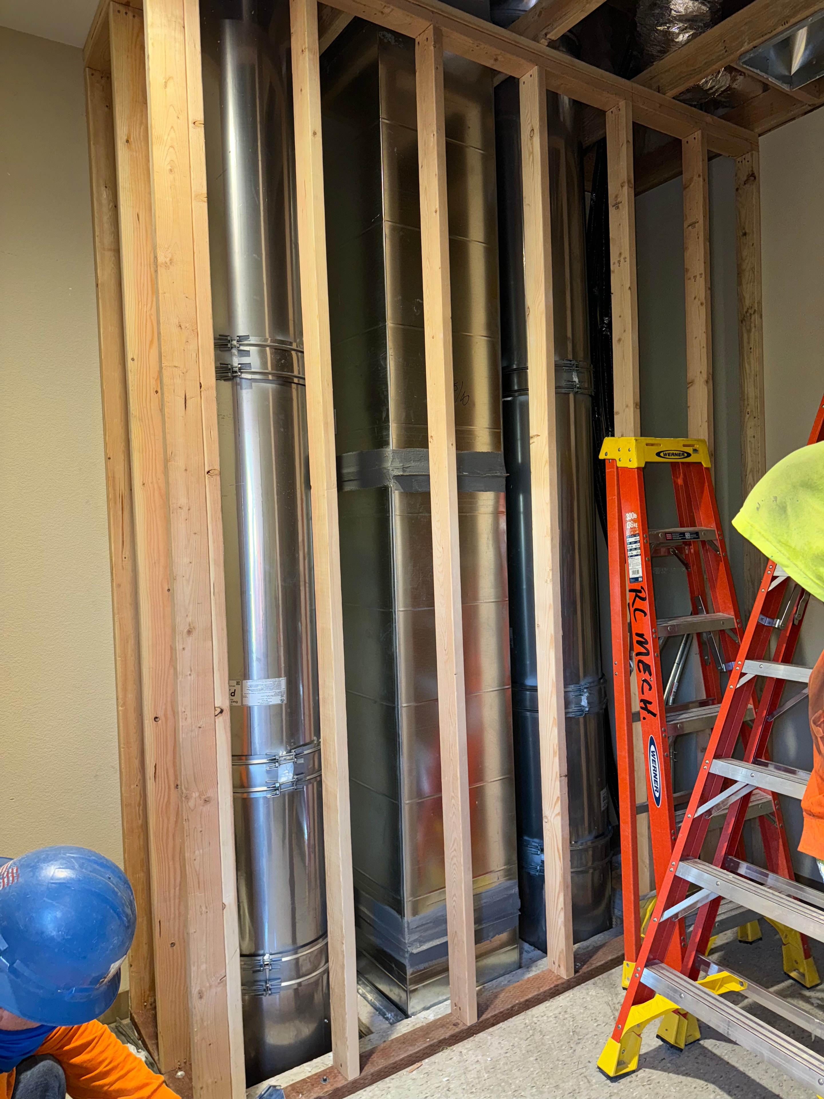 Stainless grease duct risers through framed wall chase